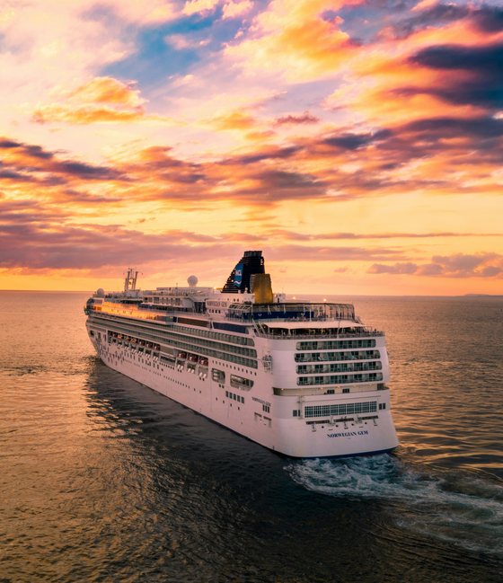 Cruise ship sailing into a sunset