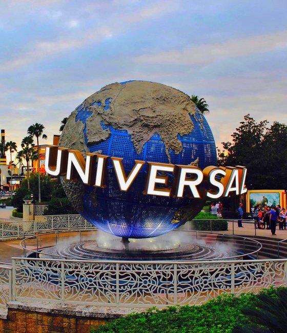 The spinning Universal globe fountain at Universal Orlando Resort at dusk