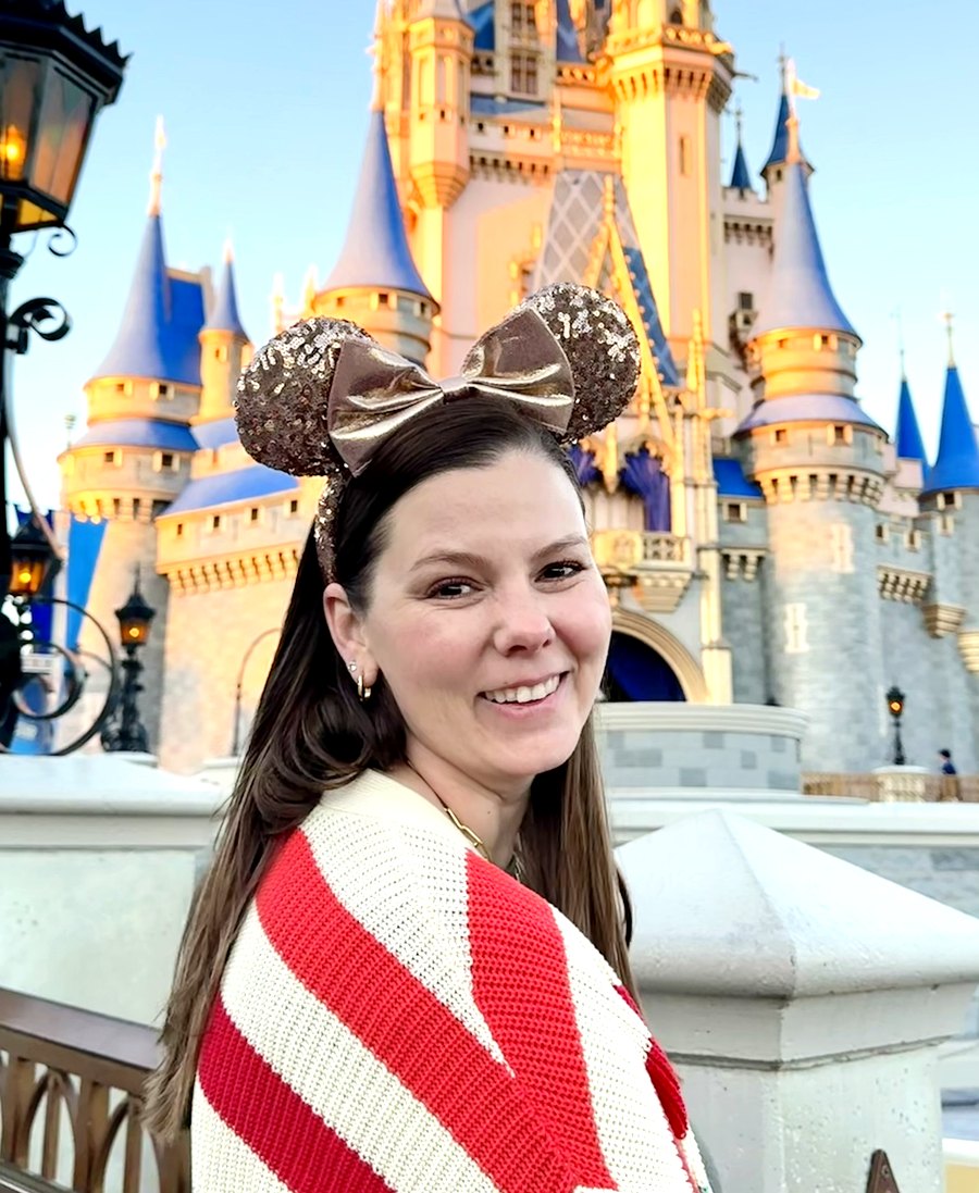 Victoria Dillon smiling in rose-gold Minnie ears in front of Cinderella Castle at Walt Disney World